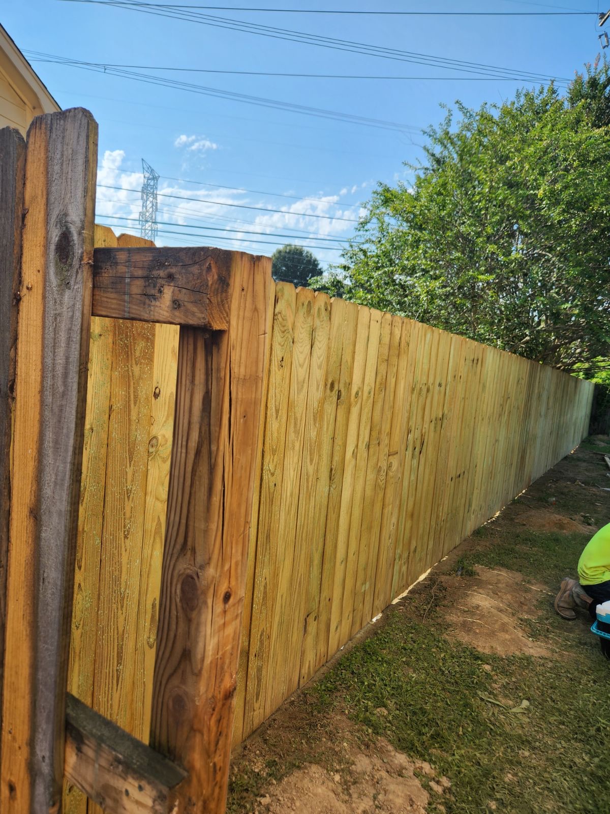 Newly installed wooden privacy fence stained in Memphis