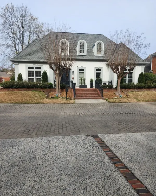 The same East Memphis house after painting, its stucco now white