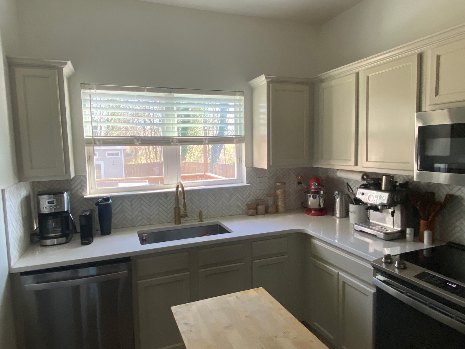 Freshly finished modern kitchen with herringbone backsplash painted by Dario's Painting