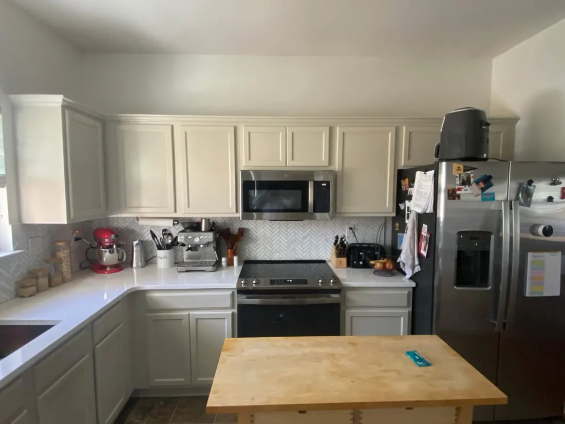 The same kitchen after the cabinets were sprayed a soft greige